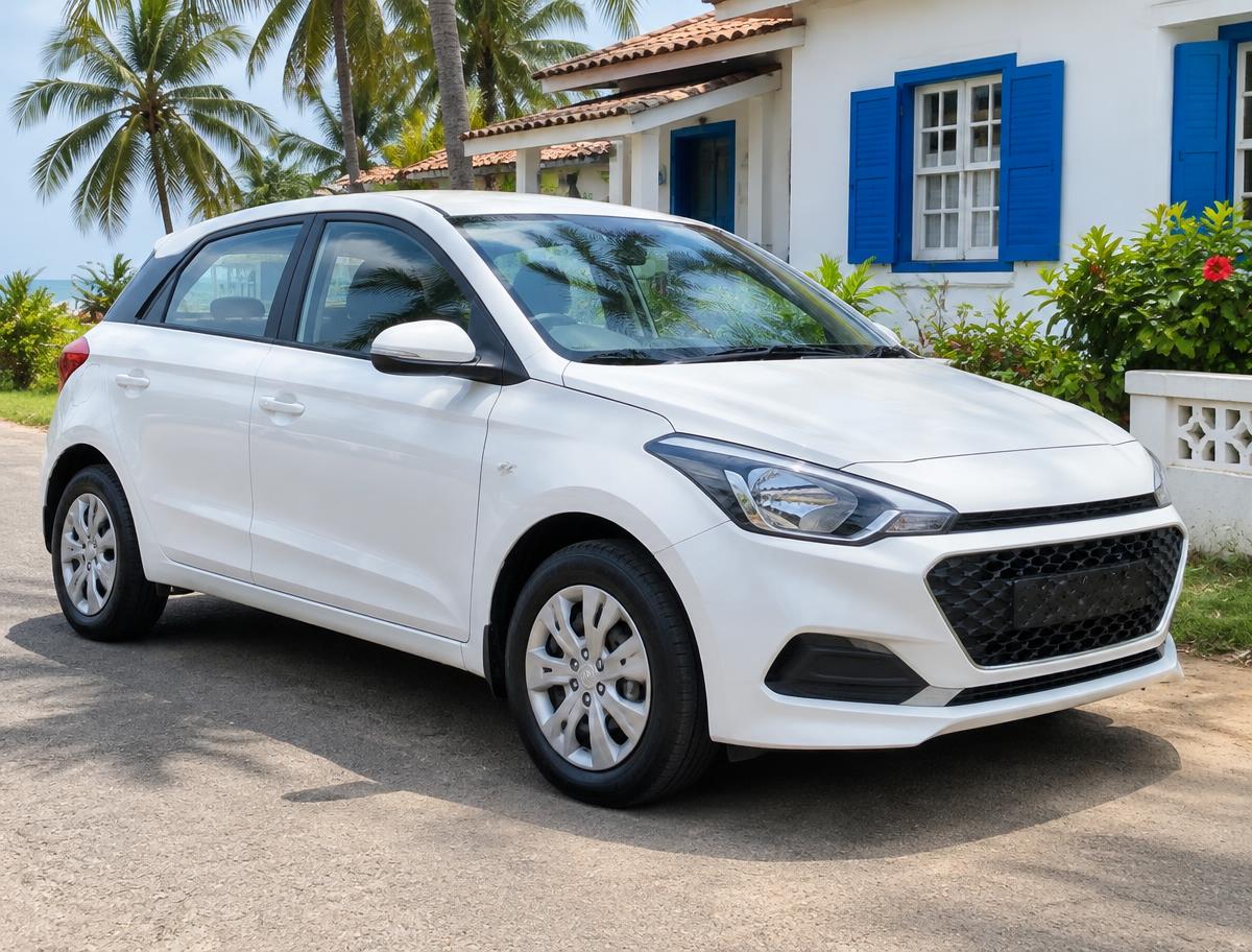 White self-drive hatchback outside a Goan house